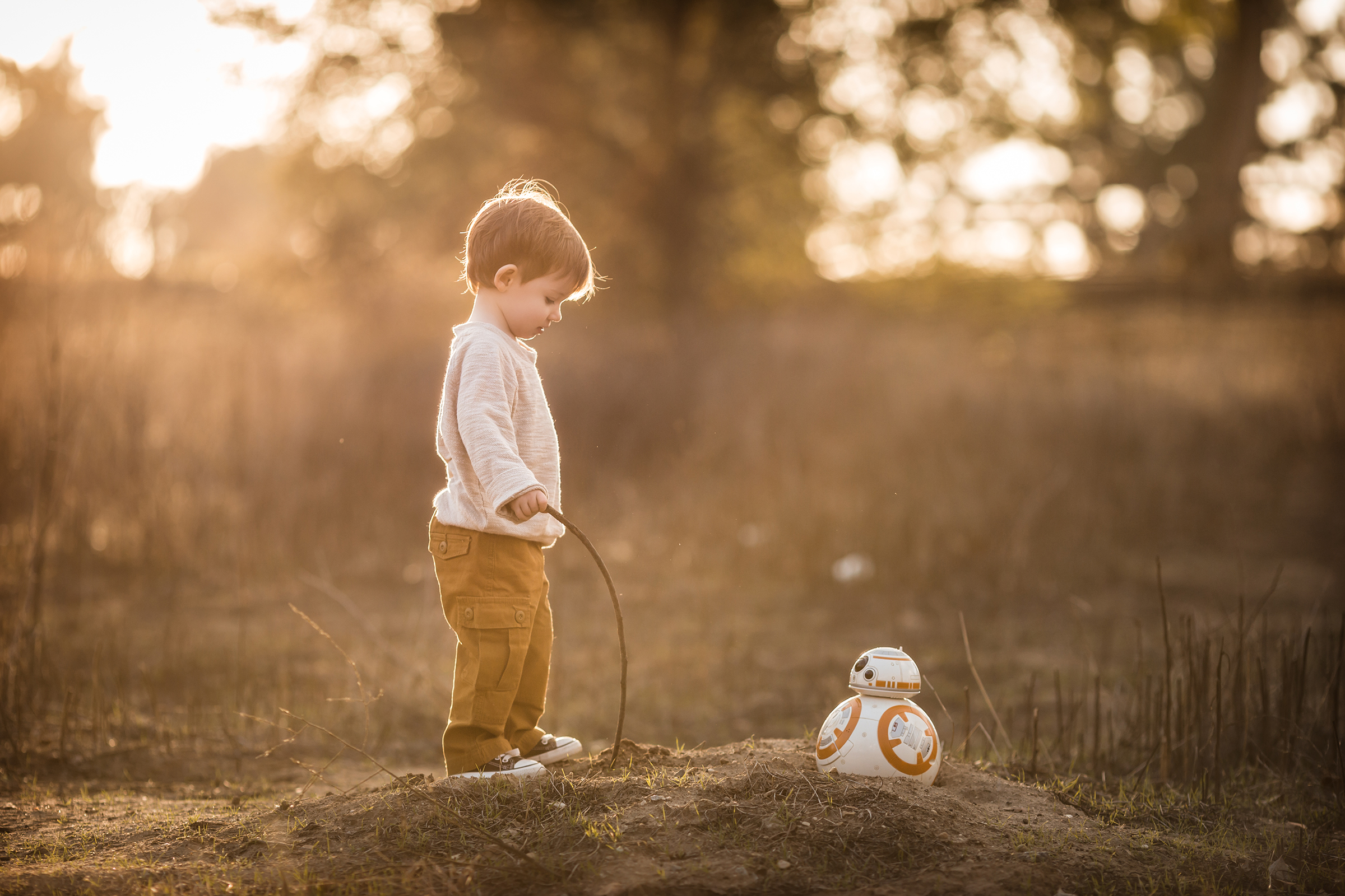 little boy with star wars bb8 outside